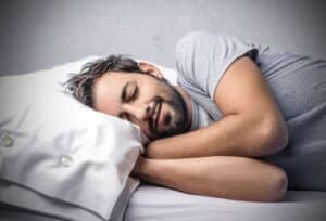 A man sleeping on a white pillow